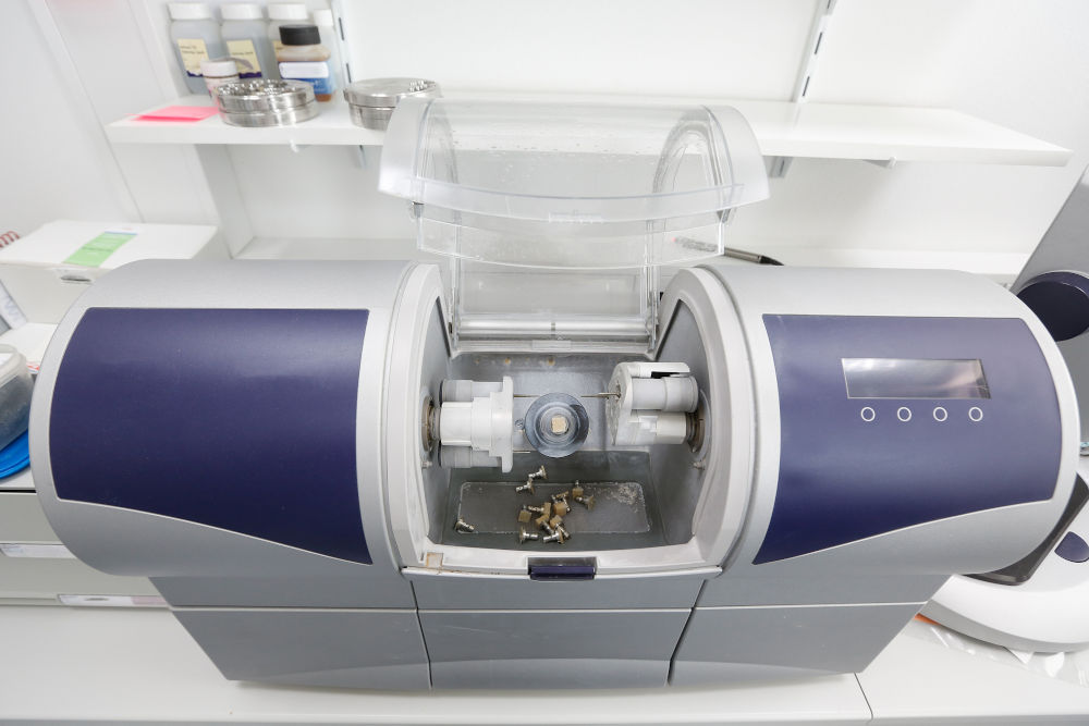 Dental CAD-CAM machine used to fabricate porcelain veneers and other ceramic restorations in modern cosmetic dentistry laboratories.